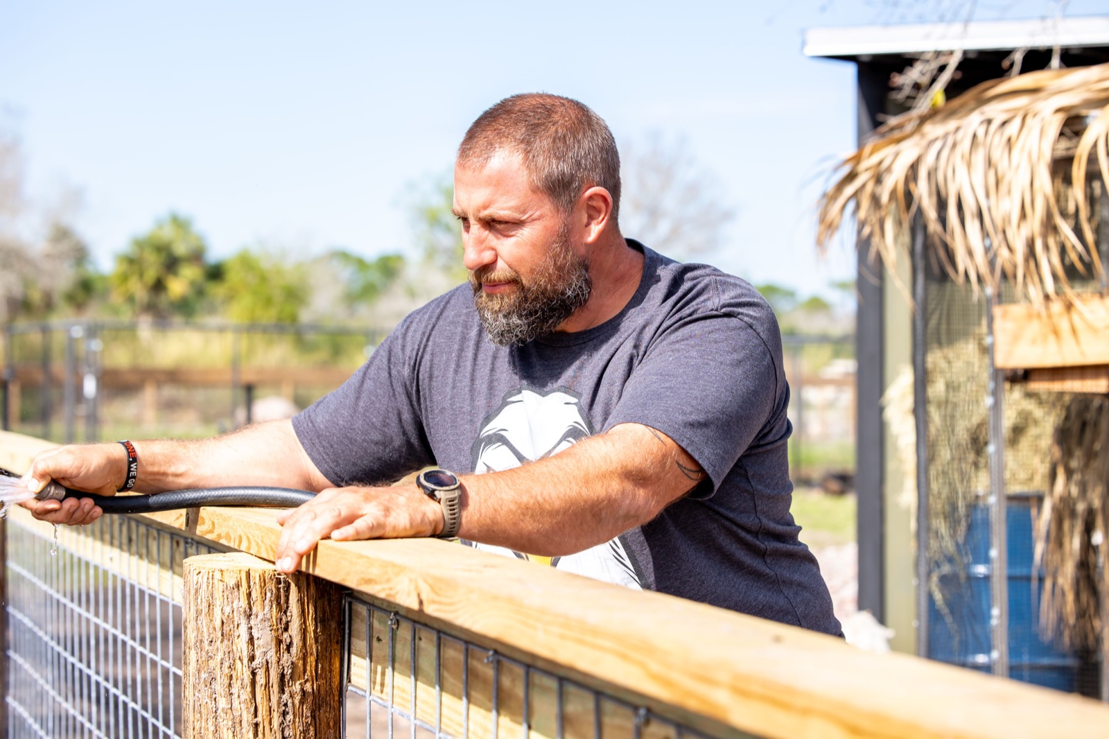 Caring for an animal enclosure at Conquer Ranch